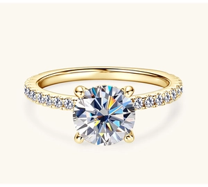 Close-up of 2 carat moissanite ring with four-prong setting and pavé gold band