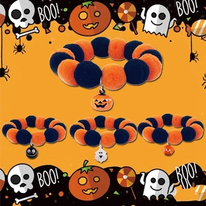 Halloween pet collar with orange and black plush balls and festive pumpkin ghost charms