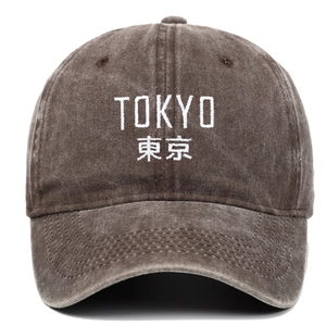 Close-up of vintage washed coffee baseball cap with white Tokyo embroidery detail