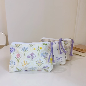 Three minimalist floral cotton coin purses in blue and purple patterns with white zippers