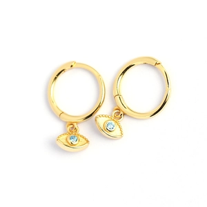 Gold s925 silver hoop earrings featuring blue crystal devil's eye charms on white background