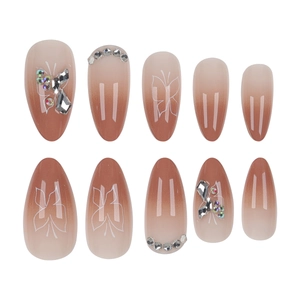 Short almond press-on nails featuring nude gradient with butterfly art and rhinestones