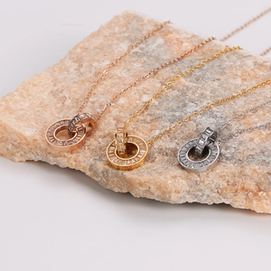 Interlocking double ring pendant necklace in gold, rose gold, and silver finishes