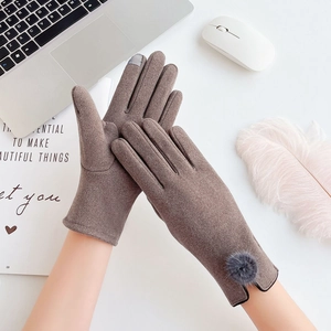Brown thermal touchscreen gloves with faux rabbit fur ball on white aesthetic background