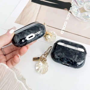 Close-up of black marble texture case for AirPods Pro with golden shell and pearl chain