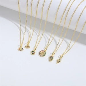 Set of six gold necklaces with Tree of Life and Evil Eye pendants on white background