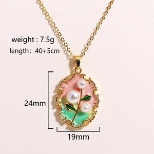 Detail shot of vintage oil painting style pendant with natural pearls and green enamel