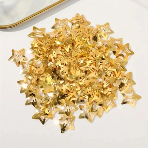 Golden star-shaped metal hair clips in bulk on white background for women styling