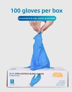Close-up of blue vinyl nitrile blend powder-free gloves being pulled from a dispenser box