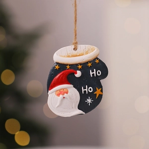 Close-up of a resin Christmas glove pendant with Santa Claus motif and a rustic twine rope