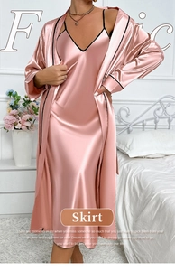 Detail of pink silk satin two-piece sleepwear set with elegant black piping and belt