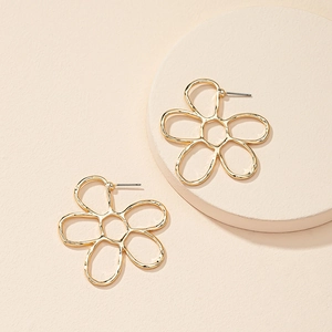 Minimalist gold hollow flower earrings with textured five-petal design on display