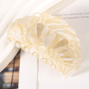 Detailed view of beige marbled acetate shell hair claw with hollow out design