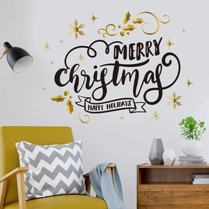 Détail de l'autocollant mural Joyeux Noël noir et or avec flocons sur mur intérieur cosy