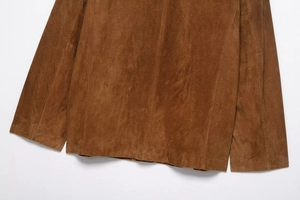 Detailed texture of dark brown suede leather jacket with premium stitching and hem
