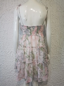 Détail du dos de la robe à fleurs rose à volants avec bretelles sur mannequin