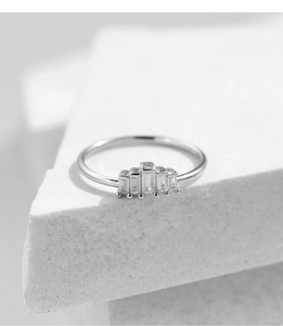 Detail of S925 sterling silver ring featuring five emerald-cut cubic zirconia stones