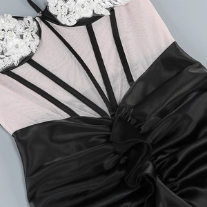 Detail of pink mesh bodice with lace flowers, pearls and black satin ruching