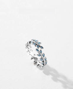 Macro detail of S925 silver leaf ring set with round blue turquoise stones