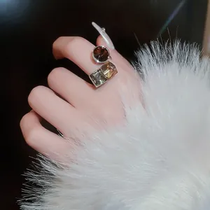 Gold-plated open ring with cubic zirconia stones in brown and champagne hues