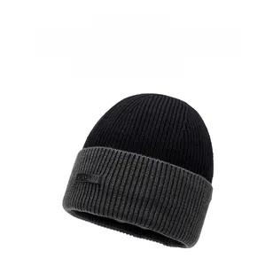 Close-up of ribbed knit texture and leather patch on warm winter beanie hat