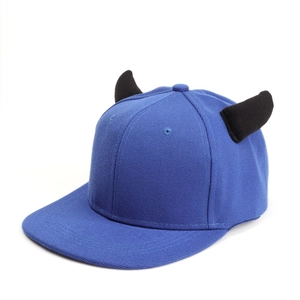 Detailed close-up of blue hip hop flat brim hat featuring 3D black devil horn accents
