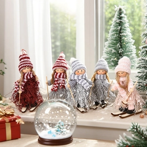 Handcrafted wooden Christmas ski dolls with knitted hats and scarves on festive windowsill