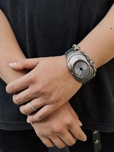 Silver Y2K men's quartz watch with unique asymmetric grey dial worn on wrist