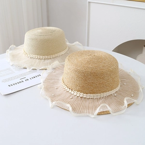 Flat top woven straw hat with white lace trim and pearls for summer sun protection