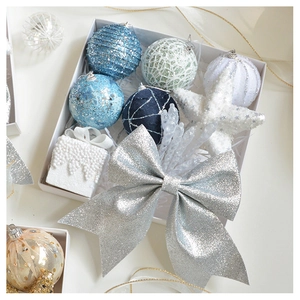 Detailed view of champagne and blue Christmas ornaments with glitter and sequins in a gift box