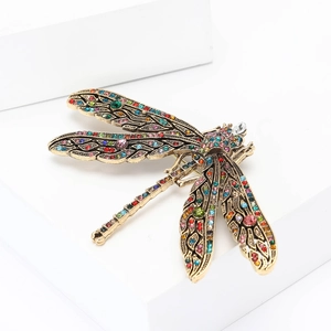 Elegant vintage dragonfly brooch with colorful rhinestones on a white background