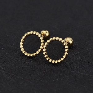 Detailed view of golden beaded hoop earrings with a high-polished mirror finish and screw back