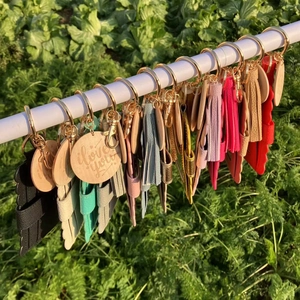 Close-up of colorful PU leather tassel keychains with engraved i love you round charms