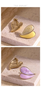 Detailed tile display of asymmetric oil painted heart earrings in yellow and purple hues
