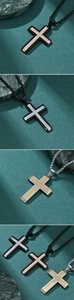 Close-up of hip hop cross pendants in two-tone finishes including gold and rose gold