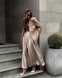 Street style detail of high-waist champagne satin midi skirt and khaki blazer outfit