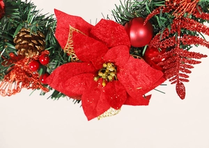 Macro shot of 40cm Christmas wreath with red velvet flowers, gold pinecones and pine needles