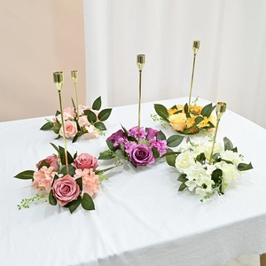 Top view of five golden metal candle holders with assorted colored rose and hydrangea rings