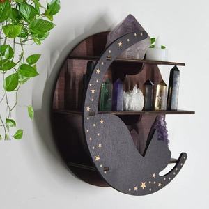 Detail of moon cat wooden crystal shelf featuring star patterns and healing stones
