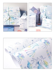 Detail of nautical ocean theme wrapping paper with colorful fish and coral watercolor art