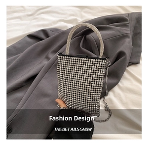 Detailed close-up of a silver rhinestone mini square handbag with metal chain and handle