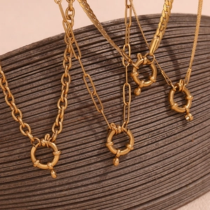 Detail of 18K gold plated stainless steel necklaces featuring round spring clasps