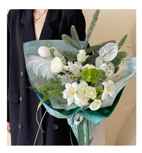 Close-up of Happy Christmas gift wrapping paper with white roses and pine branches