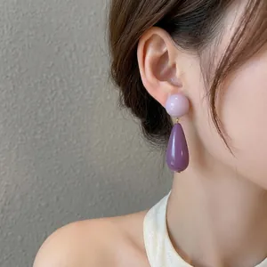 Elegant purple acrylic double-drop earrings shown on model for a retro vintage aesthetic