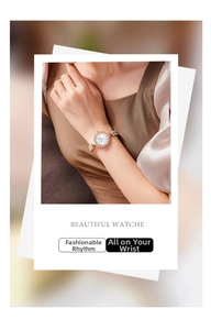 Close-up of rose gold mermaid bracelet watch with diamond bezel and scale metal strap
