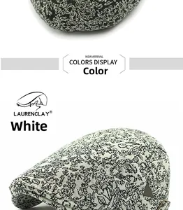 Detail of white jacquard flat cap featuring black floral patterns and metal side buckle