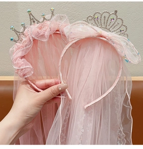 Detailed close-up of pink tulle crown headbands with sparkling rhinestones and silver finish