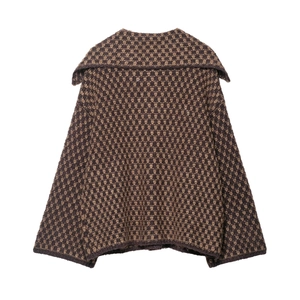 Macro shot of brown knit cardigan featuring detailed geometric texture and turn-down collar