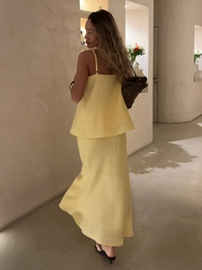 Detailed back view of a light yellow two-piece cotton camisole and fishtail skirt set