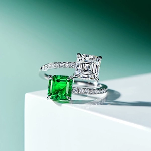 Macro view of double square emerald and diamond open ring with shimmering accents